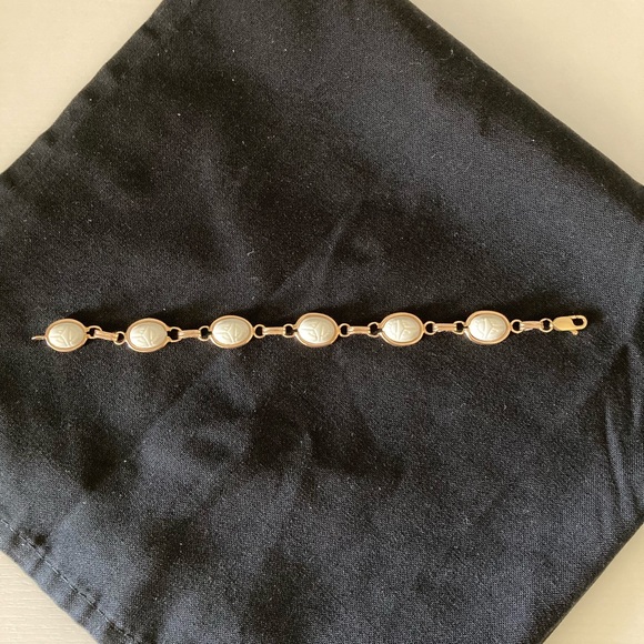 White scarab bracelet set in 14k gold